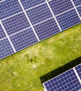 Third part of solar panels in meadow